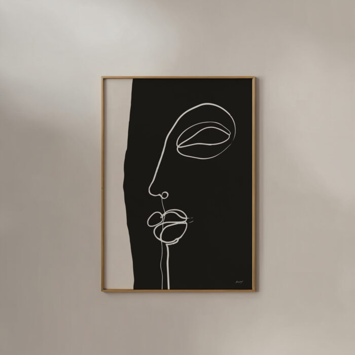 Minimalist white line face drawing on black background in simple wooden frame.