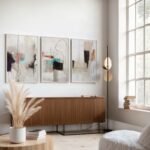 Minimalist triptych art with beige, teal and black brushstrokes in contemporary neutral room