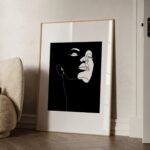 Minimalist black profile silhouette print in light wood frame against neutral wall