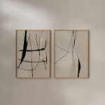 Minimalist black line art abstract prints in wooden frames, mounted on white wall.