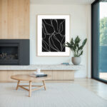 Minimalist living room featuring abstract black and white botanical line art above modern fireplace.