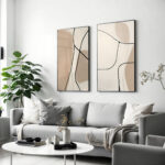 Minimalist living room with abstract line art prints and neutral color palette.