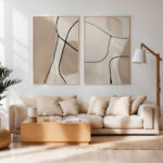 Minimalist abstract wall art duo in black and beige above neutral sofa.
