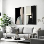 Minimalist living room with abstract wall art, gray sofa, and indoor plants.
