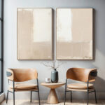 Abstract art paired with minimalist furniture creates a serene living space with warm tones.