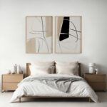 Modern bedroom with abstract black line art displayed above white bed
