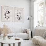 Light-filled minimalist living room with abstract wall art and neutral furnishings.