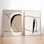 Minimalist abstract art prints with curved lines and circles in light wooden frames.