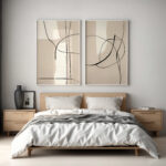 Minimalist bedroom with platform bed and abstract line art prints above headboard.