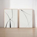 Modern abstract black line art diptych with elegant brushstrokes on light background.