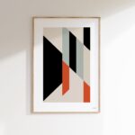 Geometric abstract art print with black, green, and orange shapes in minimalist wooden frame