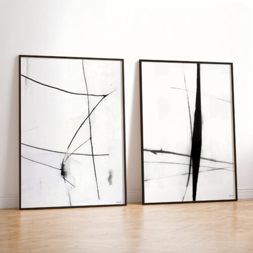 Two framed minimalist black line art prints against white wall in modern interior.