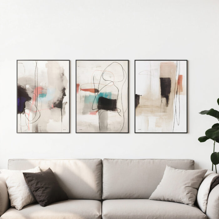 Elegant neutral abstract triptych artwork above beige sofa in contemporary living room