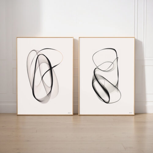 Two framed abstract artworks with fluid black brushstrokes on white backgrounds.