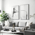 Abstract line art prints above gray sofa in minimalist living room.