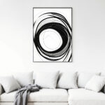 Minimalist black circular brushstroke artwork displayed above white sofa with gray throw blanket.