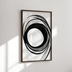 Abstract black spiral brushstrokes creating a vortex effect in a wooden frame.