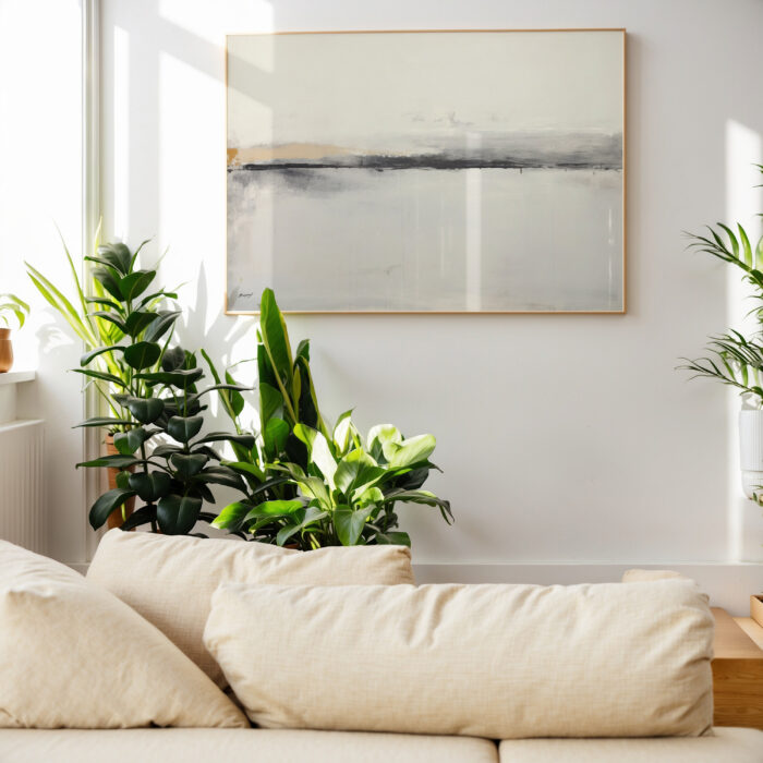 Abstract landscape painting above white sofa surrounded by houseplants in bright living room.