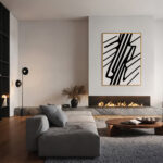 Black and white geometric art above modern fireplace in minimalist gray living room.