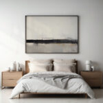 Minimalist bedroom featuring wooden bed frame with neutral bedding and abstract landscape artwork.