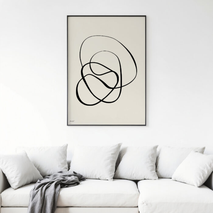 Elegant abstract black line art framed above white sofa in minimalist living room.