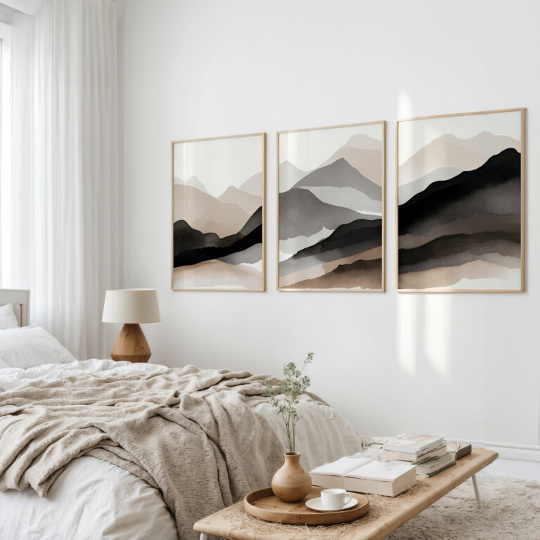 Minimalist mountain triptych artwork above bed in serene neutral-toned bedroom