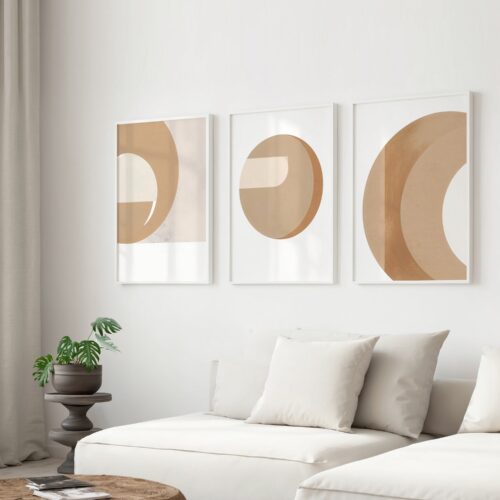 Minimalist beige triptych art with circular patterns above white sofa in modern living room.