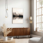 Minimalist living room with monochromatic forest artwork above wooden mid-century credenza.