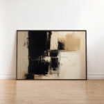 Abstract black and beige painting with bold brushstrokes displayed against white wall on wooden floor.