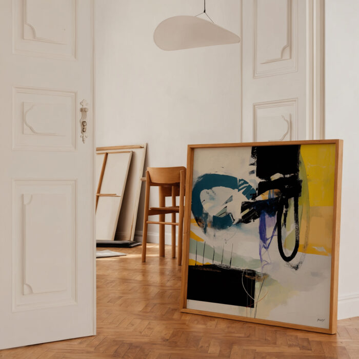 Abstract painting with black, teal and yellow brushstrokes in minimalist gallery space.