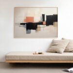 Modern geometric abstract art above sleek wooden daybed with beige cushion.