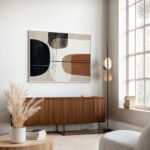 Abstract geometric wall art above wooden credenza in modern minimalist living room.