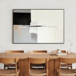 Abstract geometric art in black and white above wooden mid-century dining set