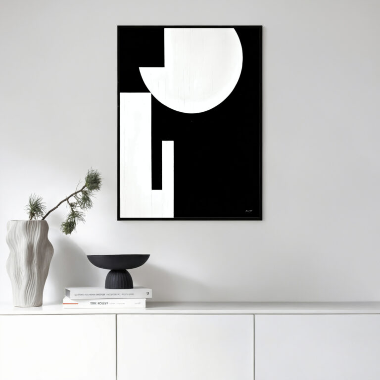 Minimalist black and white abstract art with circular form above modern white cabinet
