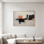 Geometric abstract painting in black, orange and beige above cream sofa in modern living room.