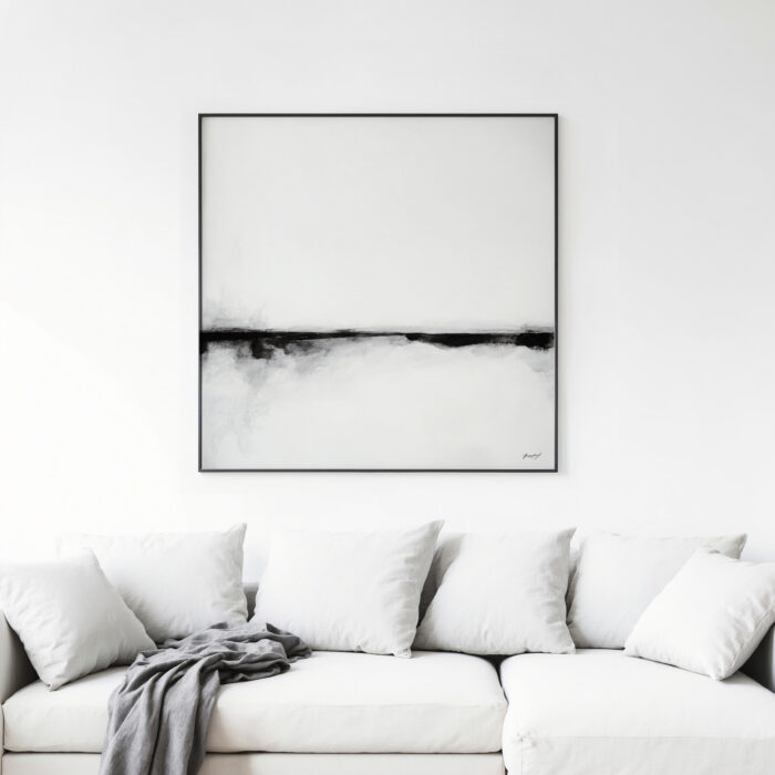 Minimalist black and white abstract art above white sofa in contemporary living space