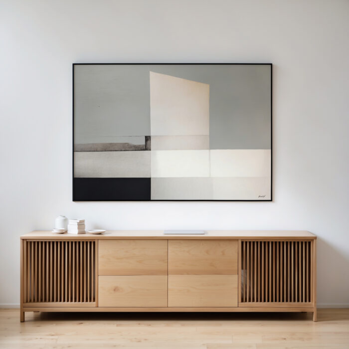 Minimalist abstract geometric artwork in gray, white and black above wooden credenza.