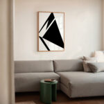 Sleek living room with modern L-shaped sofa and striking black triangle art