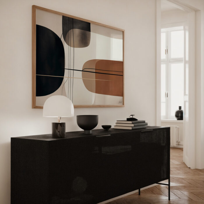 Modern abstract artwork with geometric shapes displayed above sleek black credenza in minimalist living room.
