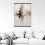 Abstract neutral painting hanging above white sofa with cushions and gray throw blanket