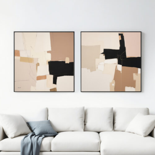 Two modern geometric abstract paintings in earth tones displayed above white sofa