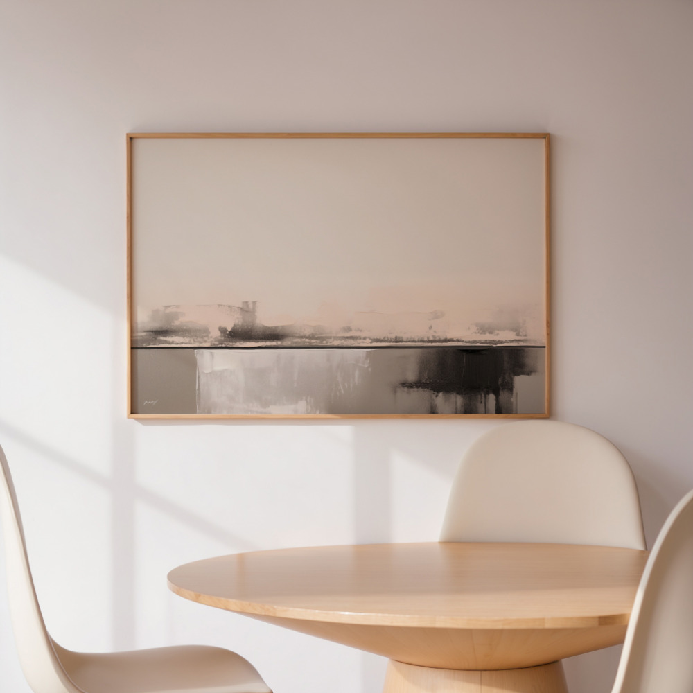 Abstract landscape artwork above round wooden table and white chair in minimalist setting.
