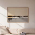 Minimalist abstract landscape painting hung above white sofa in modern living room.