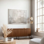 Abstract gray and beige canvas artwork with soft brushstrokes in minimal living space.