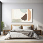 Abstract wall art with organic shapes in muted colors above minimalist bed.