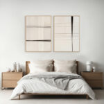 Minimalist black line art prints above bed in serene modern bedroom.