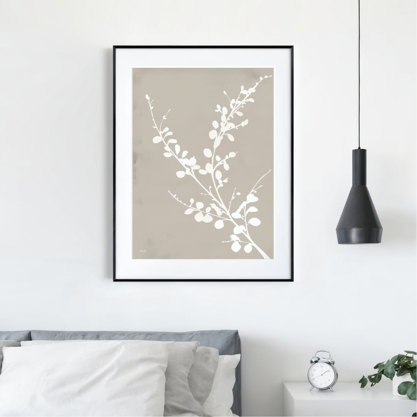 Elegant botanical artwork with white branches above bed in minimalist bedroom setting.
