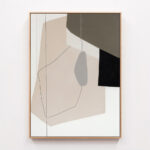 Abstract geometric artwork with beige background and black angular shape in wood frame.