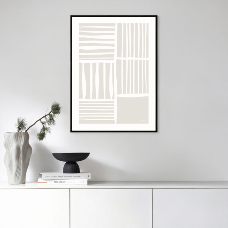 Minimalist geometric line art print framed above white cabinet with curated decor.