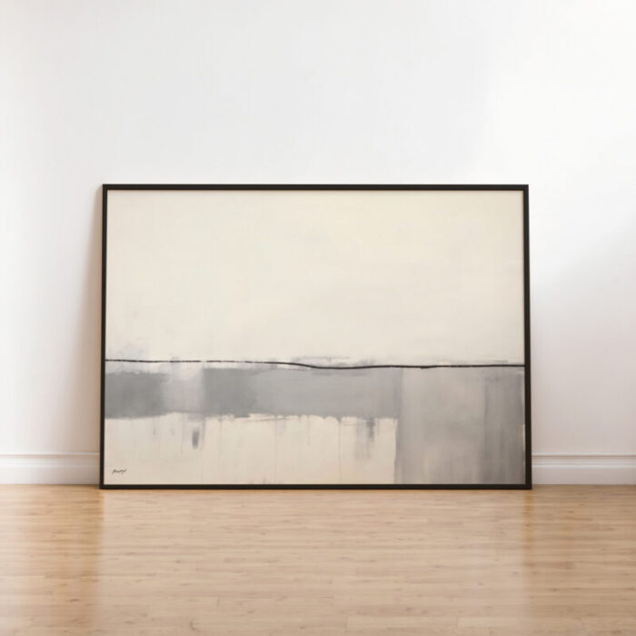 Large minimalist abstract painting with cream and gray horizon effect leaning against white wall.